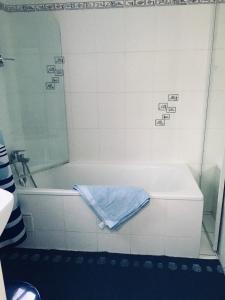 a bath tub with a towel sitting on top of it at Villa Fleur de Sel in Fouras