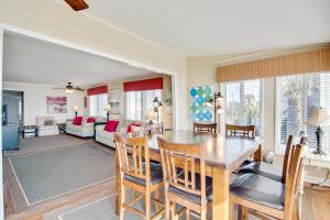 a dining room and living room with a table and chairs at Just Beachy in Folly Beach