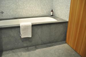 a bathroom with a bath tub and a towel at Chesa Chavriol in Pontresina