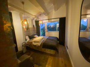 a small bedroom with a bed and a mirror at Cannes cote sud in Cannes +18 photos