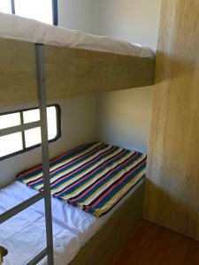 a bunk bed in a small room with a ladder at Patitos in Huarmey