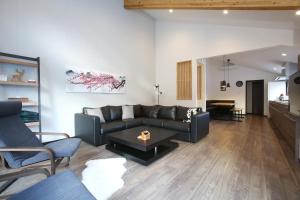 a living room with a couch and a table at Snowlines Apartments Hakuba in Hakuba