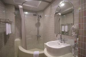 a bathroom with a sink and a shower at Moroccan Holiday Suite in Hualien City