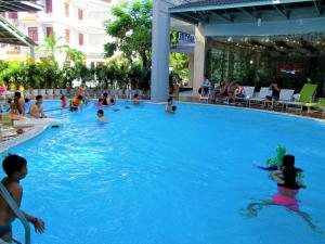 a group of people swimming in a swimming pool at Anh Dao Mekong 2 Hotel in Can Tho