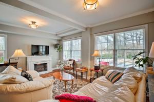a living room with two couches and a fireplace at Cheery Cottage with Yard Less Than 1 Mile to Marietta Square in Marietta