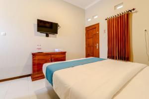 En eller flere senger på et rom på Guesthouse Nusa Indah Syariah 2