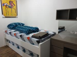 a bed in a room with a tv at Apartemen Grand sungkono Lagoon Venetian. in Surabaya