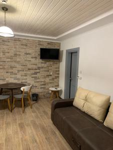 a living room with a couch and a table at M.A.K.home in Vyshka