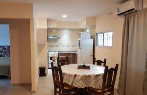 a kitchen and dining room with a table and a refrigerator at Los Franceses in San Rafael