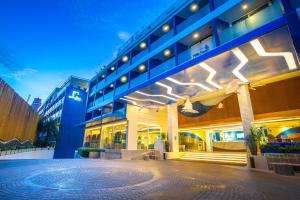 a large building with a lit up facade at night at Hotel Clover Patong Phuket in Patong Beach