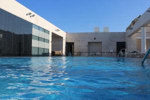 a swimming pool in front of a building at Premium Class Marina Herzeliya in Herzliya B