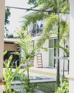 a view of the front of a house with palm trees at Green Hill Mirissa in Mirissa