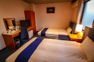 Postel nebo postele na pokoji v ubytování SPA Inn Shirahama