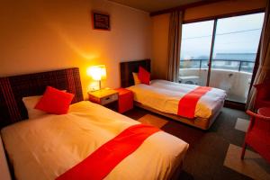 Postel nebo postele na pokoji v ubytování SPA Inn Shirahama