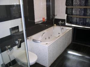 a bathroom with a bath tub and a toilet at One bedroom luxury Shota Rustaveli str in Kyiv