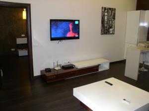 a living room with a flat screen tv on a wall at One bedroom luxury Shota Rustaveli str in Kyiv