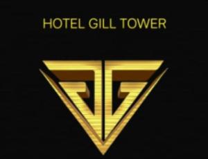 a gold logo with the words hotel gill tower at HOTEL GILL TOWER (GRAND) in Hanumāngarh +1 photo