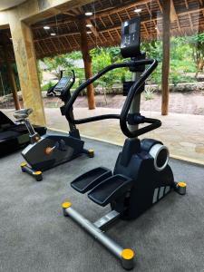 a gym with two exercise bikes on the floor at Tulia Zanzibar Unique Beach Resort in Pongwe