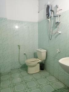 a bathroom with a toilet and a shower in it at The Madampa Sea Side Lodge in Ambalangoda