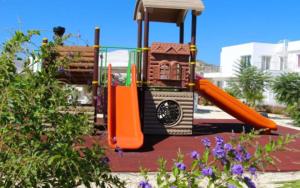 a playground with an orange slide in a park at Апартаменты в комплексах Цезарь Бич и Цезарь Блю in Boğaz +40 photos