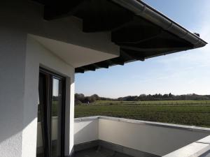 a view from the balcony of a house with a view of a field at Eifelpension-Radlertraum in Blankenheim