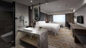 Postel nebo postele na pokoji v ubytování The Howard Plaza Hotel Kaohsiung