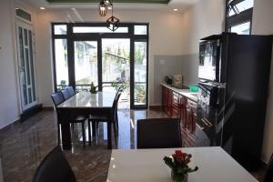 a kitchen and dining room with a table and chairs at Villa Suối Mùa Xuân in Da Lat