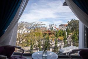 a window with a view of a city at Villa Suối Mùa Xuân in Da Lat