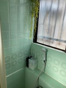 a bathroom with a blow dryer and a window at CASA KUNISAKU in Machida