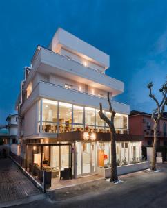 a large white building with lights on at Hotel Rubens in Rimini