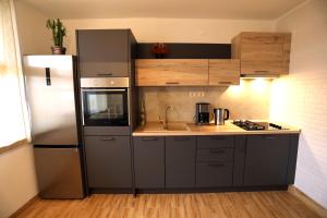 a kitchen with a refrigerator and a sink at Apartament Klara-Centar in Pula