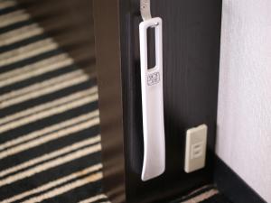 a close up of a door with a white handle at APA Hotel Nambaminami Ebisucho Eki Shinsekai in Osaka