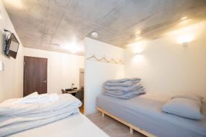 En eller flere senge i et værelse på bmj Hyakunincho