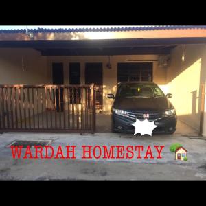 a car parked in a garage with a star on it at WARDAH HOMESTAY in Kampong Gong Badak