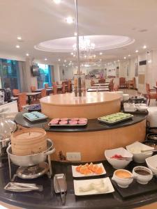 a buffet in a restaurant with food on a counter at Moonlight Hotel in Hsinchu City