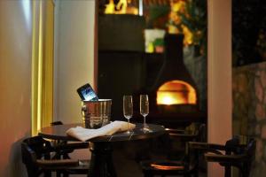 a table with two wine glasses and a laptop on it at Bed and Breakfast BLUE in BLUE in Komiža