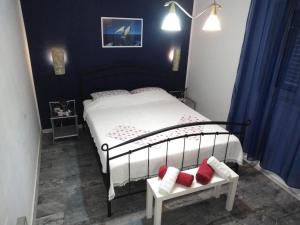 a bedroom with a bed with red pillows on it at Bed and Breakfast BLUE in BLUE in Komiža