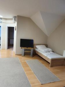 A bed or beds in a room at Bella Apartman