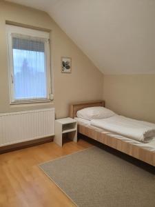 A bed or beds in a room at Bella Apartman