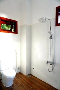 a bathroom with a toilet and a shower at Monkey Homestay & Bar in Tân Hiệp