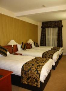 Un pat sau paturi într-o cameră la The Belfray Country Inn