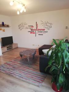 a living room with a couch and a table at Appartementhaus Silke in Bad Füssing