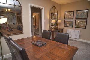 a dining room with a wooden table and chairs at Old Bakers Cottage ground floor apartment centrally located in Grasmere with patio area in Grasmere