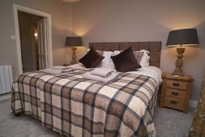 A bed or beds in a room at Old Bakers Cottage ground floor apartment centrally located in Grasmere with patio area
