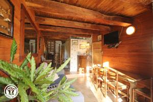 a living room with wooden walls and a table and chairs at Chambre d’hôtes de Vauguenige in Saint-Pardoux