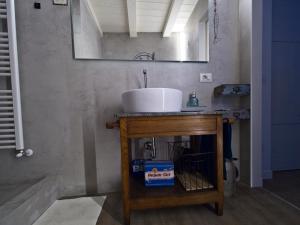a bathroom with a sink and a mirror at Light Blue Lake Aria in Argegno +19 photos