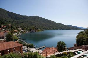 uma vista para um lago com casas e montanhas em B&B I Corni di Nibbio em Mergozzo