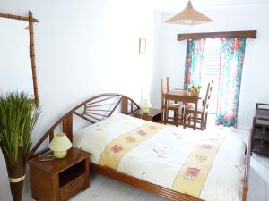 a bedroom with a bed and a table and chairs at Hotel Restaurant Les Gorges de Chouvigny in Chouvigny