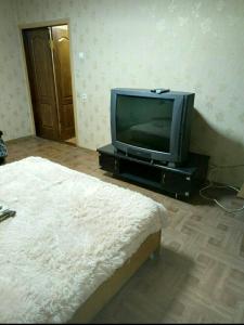 sala de estar con TV y cama en Просторная 1комнатня квартира напротив ТРЦ Дафи Ашан рядом ресторан Альтбир, en Járkov