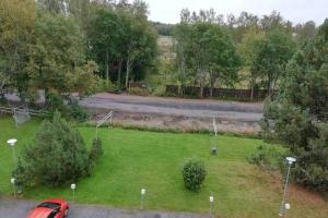 an aerial view of a yard with a red car in the grass at Nice apartment in Vaasa in Vaasa